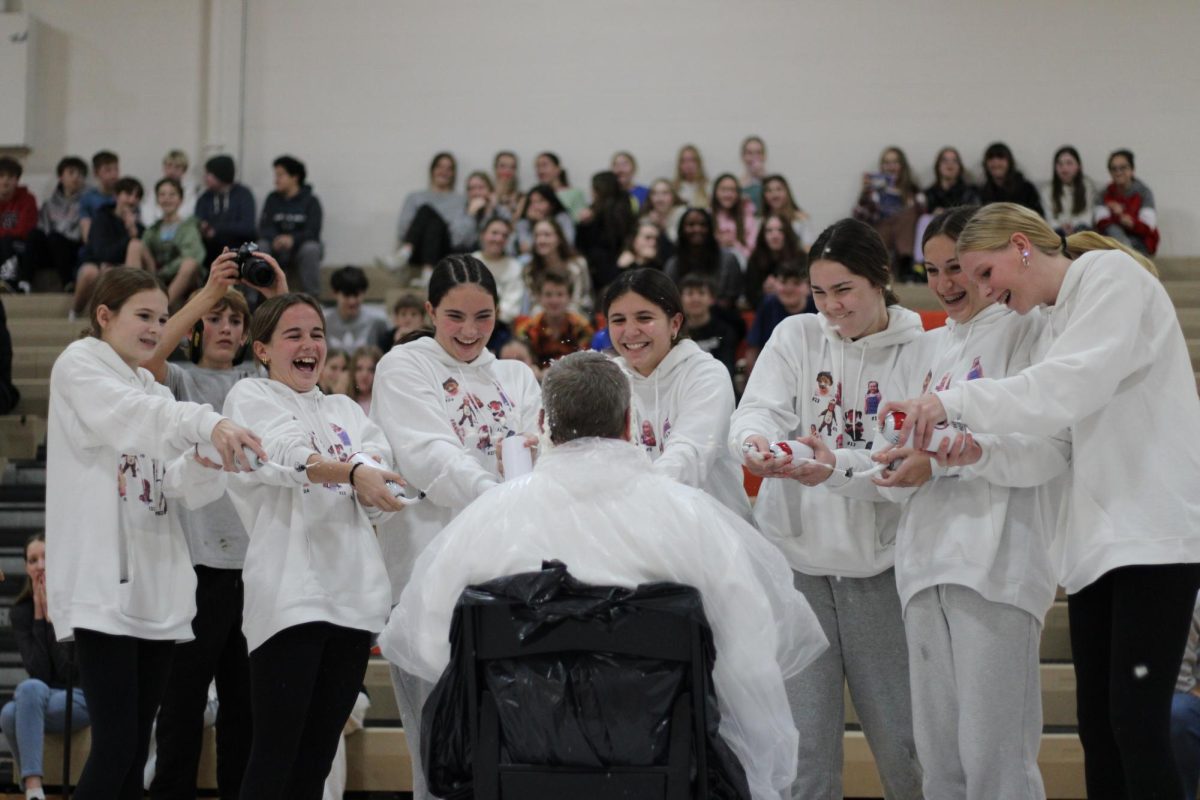 The Eighth-grade girls basketball team “Pies” their head coach, Mr. Kimball, with homemade whipped cream launchers. This is in part with an annual fundraiser letting large donors throw pie at their favorite teachers.