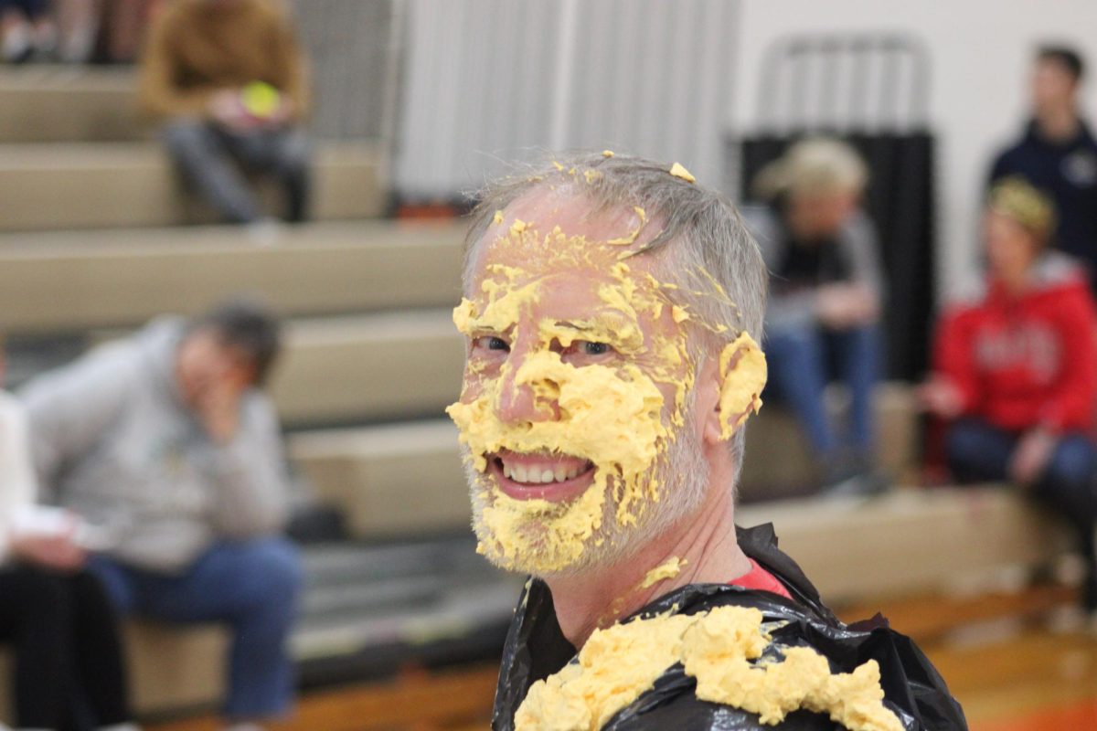 Math teacher Mr. Brown takes a look around the gymnasium after taking a pumpkin spice pie in the face for a good cause. 